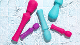 FemmeFunn wand vibrators sitting in a shallow pool of water
