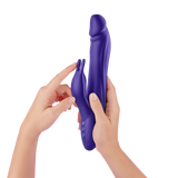 A pair of hands holding the dark purple Booster Rabbit XL to show the control buttons.