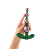 A close-up of a hand holding the Bougie Beads vertically to show their full length and design.