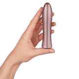 A hand holding the rose gold FemmeFunn Bougie Bullet vibrator to show its scale.