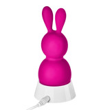The FemmeFunn Bunny Massager sitting in its charger.