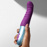 A hand holding the FemmeFunn Cadenza in purple.