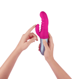 A model holding the FemmeFunn Essenza thrusting rabbit vibrator in pink.