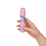 A hand holding the pink and blue ffix Wand to show its compact size and scale.
