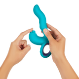 A hand holding the FemmeFunn Klio in teal. 