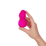 A hand holding the FemmeFunn Nubby Massager in pink.