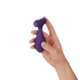 A hand holding the FemmeFunn Plua in dark purple. 