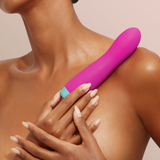 A model holding the FemmeFunn Rora bullet in pink.