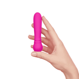A hand holding the pink FemmeFunn Ultra Bullet vibrator to show its compact and discreet size.