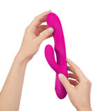 Hands holding the FemmeFunn Ultra Rabbit in pink.