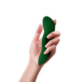 A hand holding the dark green FemmeFunn Unda panty vibrator to show its ergonomic grip.