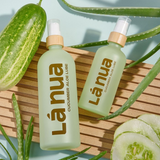 A lifestyle image showing a bottle of La Nua's Cucumber Aloe lube with fresh aloe and cucumber slices.