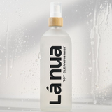 Two bottles of La Nua's Toy Cleaning Mist in a clean, stylish bathroom setting.