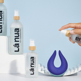 A bottle of La Nua Toy Cleaning Mist next to the Volea vibrator, showing how it's used.