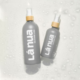 Two bottles of La Nua's unscented silicone lube arranged in a lifestyle setting.