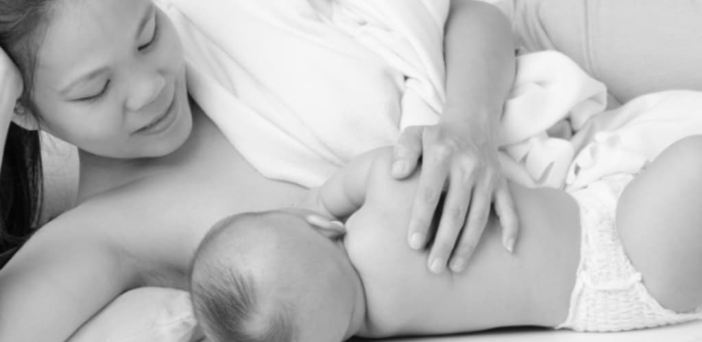 woman breastfeeding a baby - Postpartum Sex - Breastfeeding may trigger sexual pleasure