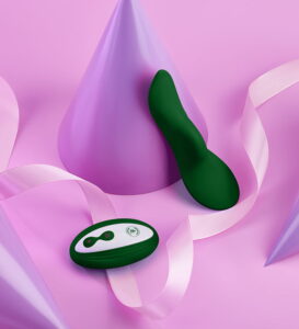 unda dark green vibrator against a purple party hat