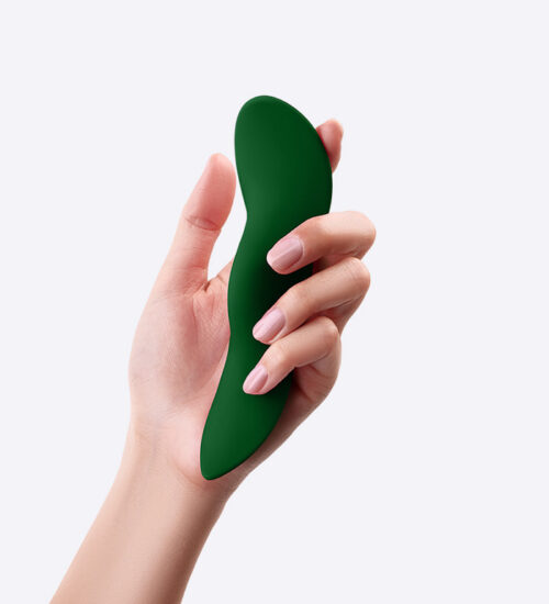 unda dark green vibrator in a woman's hand